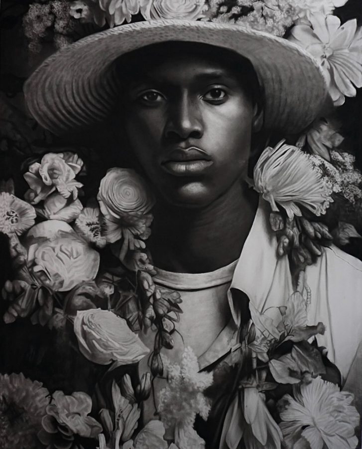 Jardim das fragilidades II by Ritchelly Oliveira: a young man in a straw hat and open shirt surrounded by dense flowers, in black and white